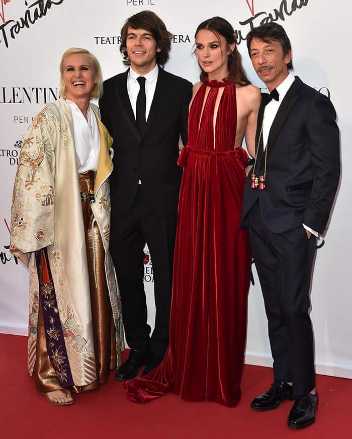 Keira Knightley turned heads in a crimson velvet Valentino gown, discreetly paired with sparkling “Strass” sandals, as she posed alongside husband James Righton and designers Maria Grazia Chiuri and Pier Paolo Piccioli at the La Traviata opening gala in Rome on May 22, 2016