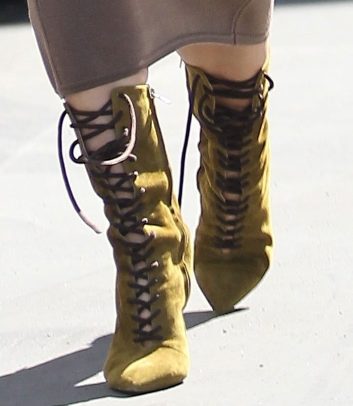 Kim Kardashian styled her taupe midi skirt with khaki suede boots