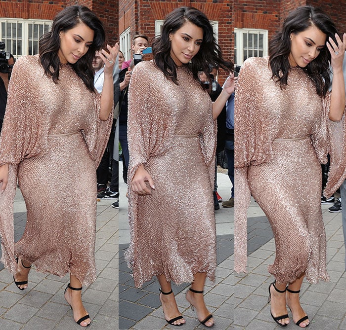 Kim Kardashian moves through the crowd in a shimmering dusty-pink Talbot Runhof dress, letting her minimal black Manolo Blahnik “Chaos” sandals anchor the glitzy look