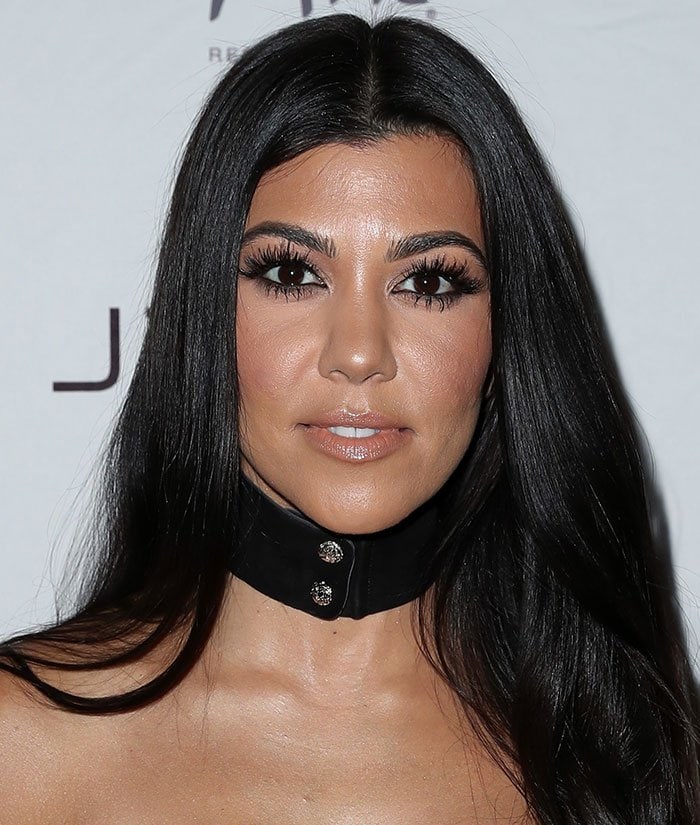 Kourtney Kardashian stuns with sleek, long hair and a bold black leather choker
