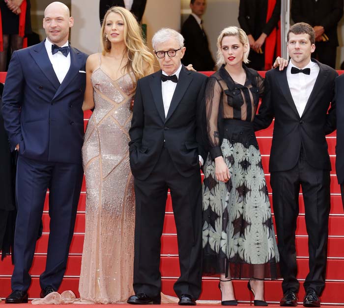 The cast and director pose together on the red carpet at the Cannes Film Festival, dressed in formal eveningwear against the iconic staircase backdrop