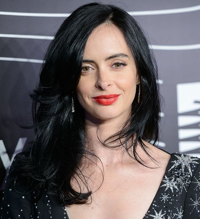 Krysten Ritter stuns with her sleek black hair and vibrant red lipstick at the 2016 Webby Awards, complementing her dazzling star-embellished outfit