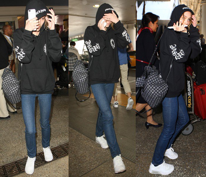 Lily-Rose Depp opts for comfort in classic white Nike sneakers, styled with skinny jeans and a hoodie for her airport arrival