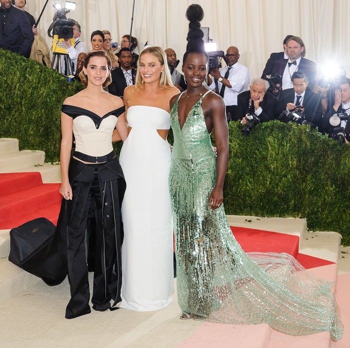 Lupita Nyong'o towers over Margot Robbie and Emma Watson, her striking sculptural updo adding extra height to her stunning presence on the red carpet