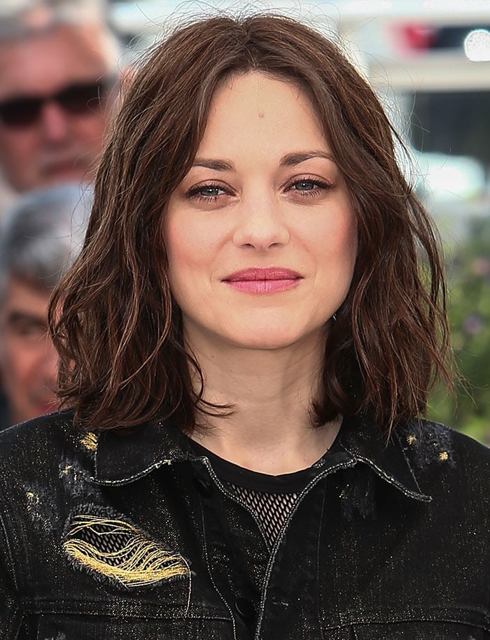 Marion Cotillard showcases her effortless beauty with tousled waves and a soft pink lip at the 2016 Cannes Film Festival