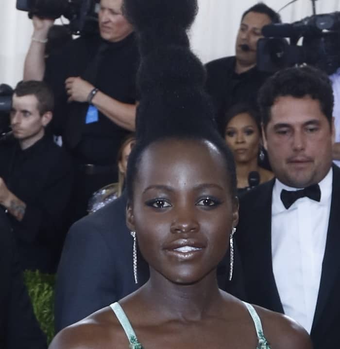 Lupita Nyong'o wears a four-bubble topknot and Tiffany Co. diamond jewelry