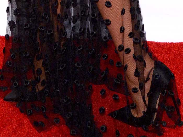 Olivia Culpo in black satin pumps