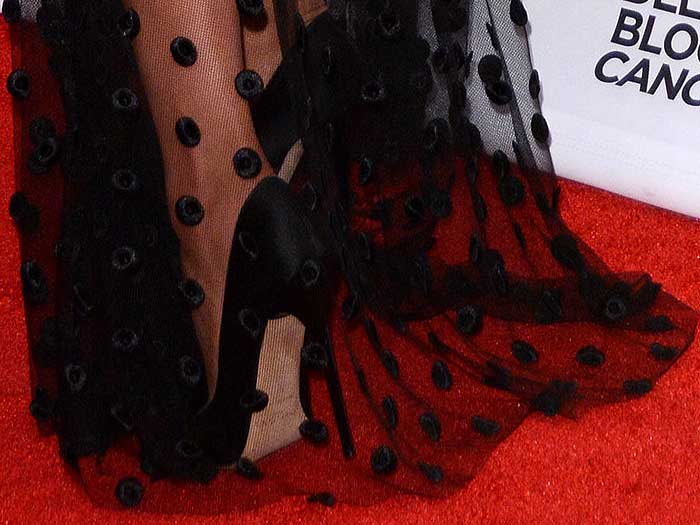 Olivia Culpo in black satin pumps