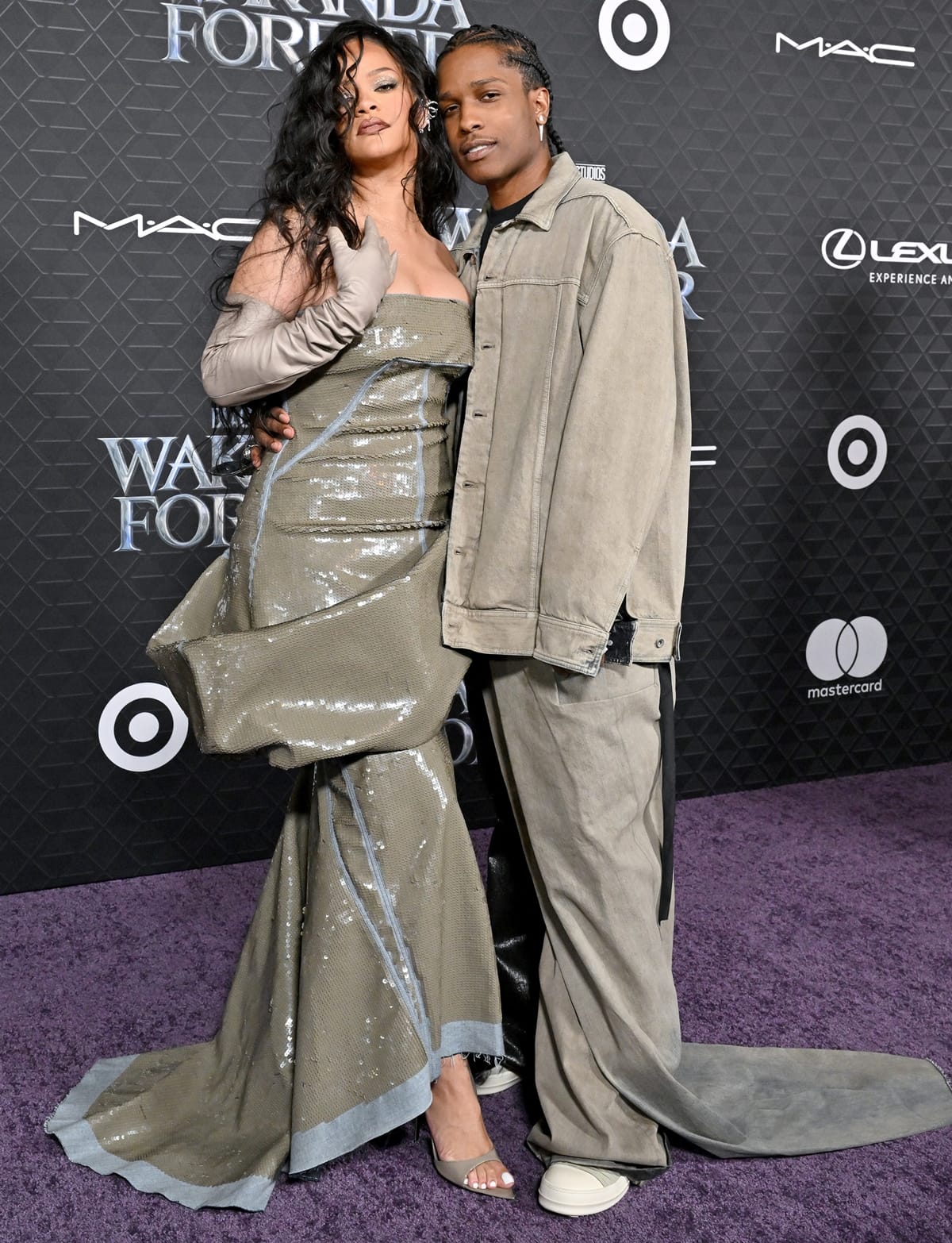 Rihanna and A$AP Rocky showcase their subtle height difference at Marvel Studios' 'Black Panther: Wakanda Forever' premiere, with Rihanna elevating her look in open-toe high heels and a shimmering strapless gown, while A$AP Rocky keeps it casual in oversized neutral-toned layers and chunky sneakers