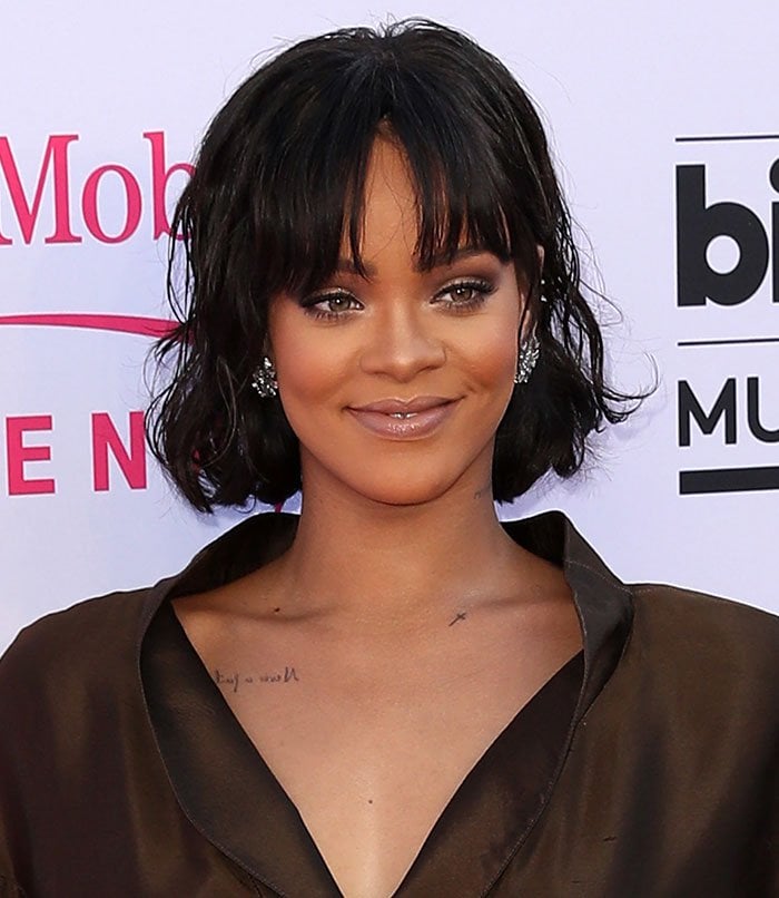 Rihanna shines at the Billboard Music Awards in a chic, brown silk ensemble paired with sparkling statement earrings