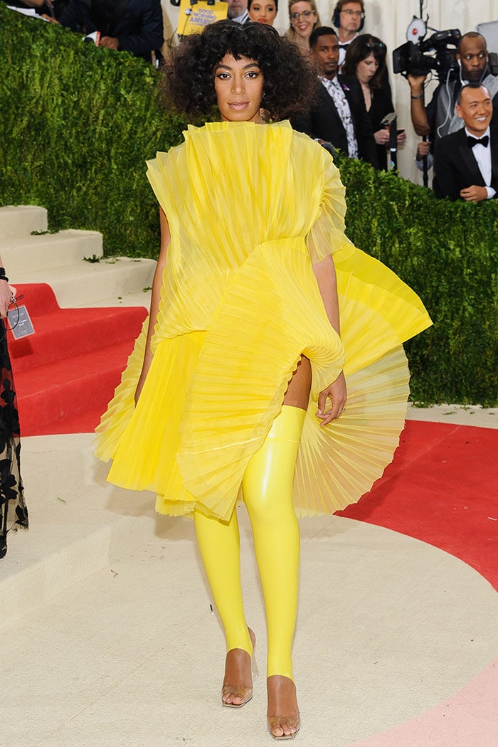 Solange Knowles stuns in a bold and avant-garde bright yellow fan-pleated dress from David LaPort’s Fall 2014 collection, making a striking statement on the Met Gala red carpet