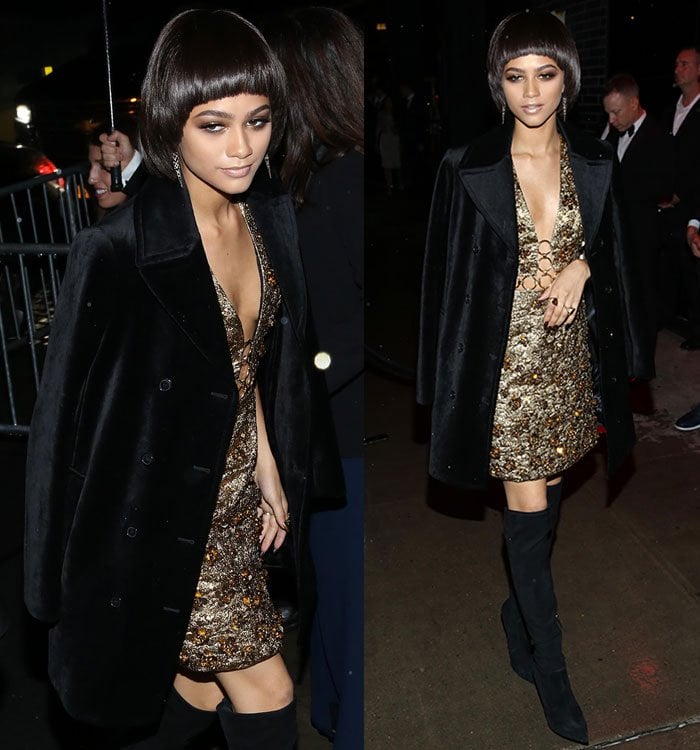 Layering effortless edge over glamour, Zendaya drapes a black velvet coat across her shoulders to complete her bold Michael Kors and Giuseppe Zanotti ensemble at the Met Gala after-party
