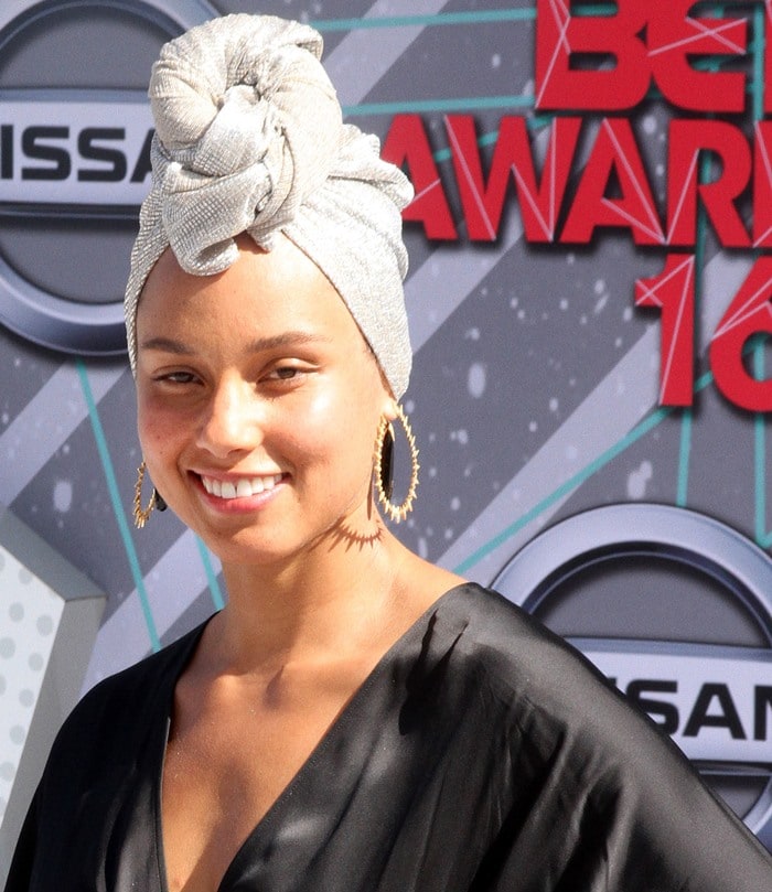 Alicia Keys beams with a natural smile, her eyes glowing as she embraces a makeup-free look at the 2016 BET Awards