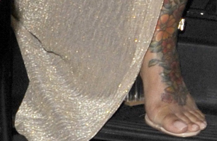 A close-up of Blac Chyna’s floral leg tattoos, nude pedicure, and transparent Yeezy Season 2 sandals highlights the barely-there footwear trend that dominated celebrity style in the mid-2010s