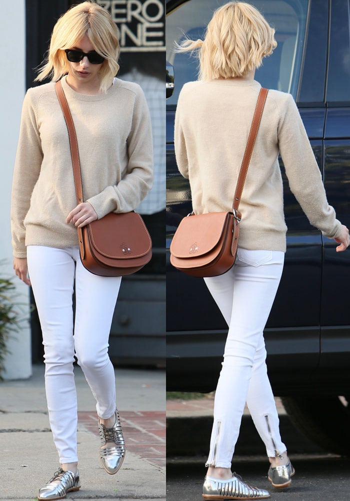 Emma Roberts rocked an AG Adriano Goldschmied Rylea crew sweater and white Rag Bone zipper trim skinny jeans