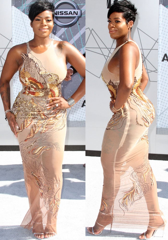 Fantasia Barrino shows off the curve-hugging silhouette of her sheer, embellished Diana Couture gown while posing in silver Giuseppe Zanotti “Coline” sandals on the BET Awards red carpet