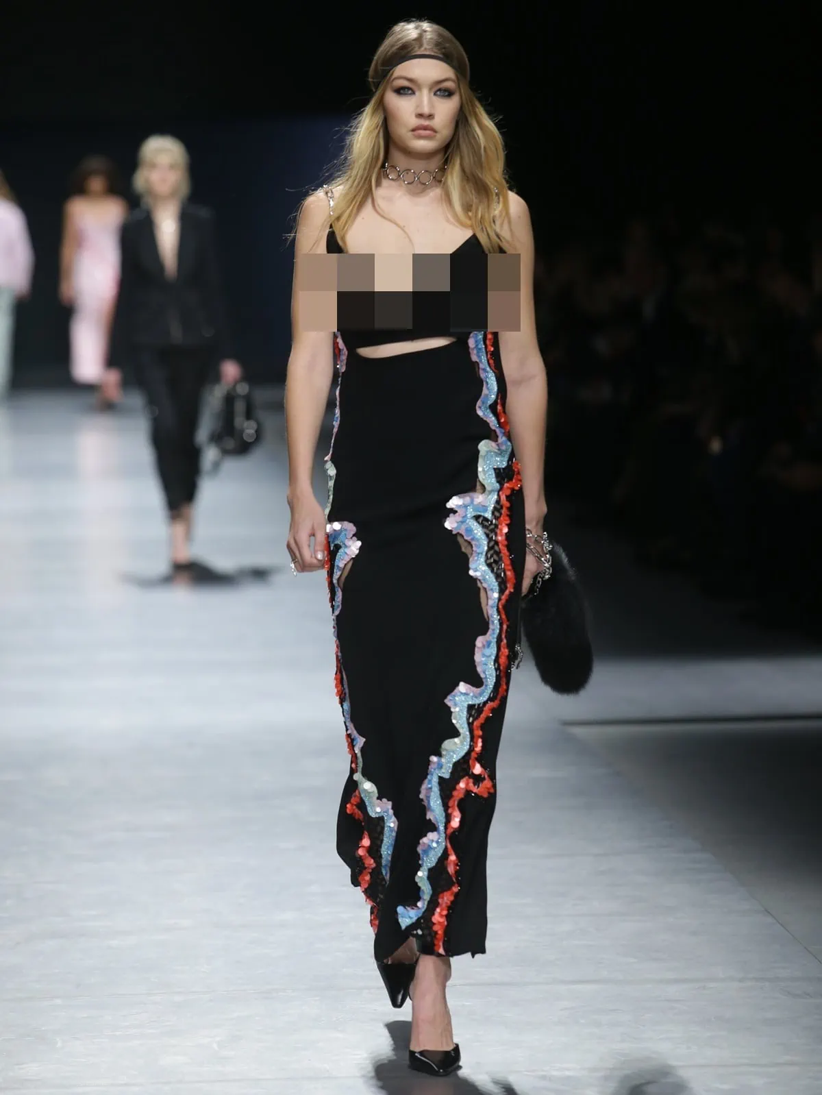 Gigi Hadid's outfit suffered a minor flaw as it failed to prevent a nip slip during her catwalk walk at the Versace fashion show