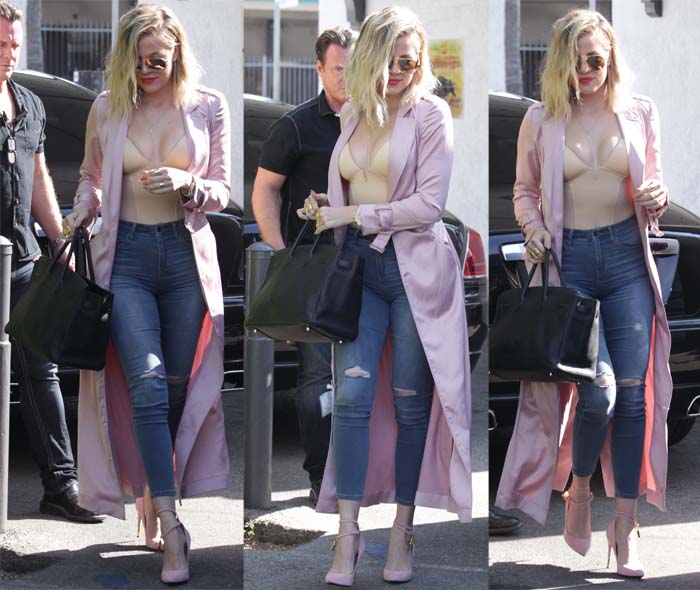 Khloé Kardashian steps out in distressed skinny jeans, a nude bodysuit, and a blush satin trench coat, finishing the look with Tom Ford double-ankle strap padlock pumps on June 8, 2016