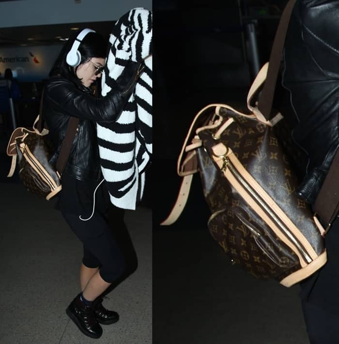 Kylie Jenner keeps it low-key at LAX on August 29, 2014, rocking a black leather jacket, cropped leggings, Zara leather mountain booties, and a Louis Vuitton Bosphore backpack for a rugged-luxe travel vibe