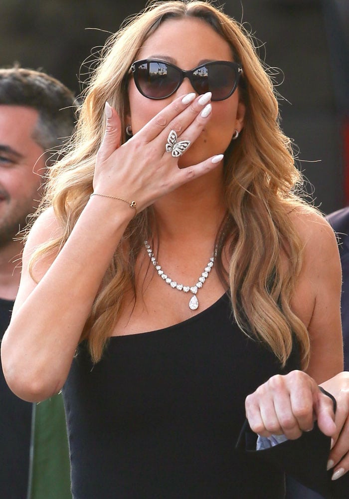 Mariah blows her awaiting fans a kiss with her butterfly ring-clad hand