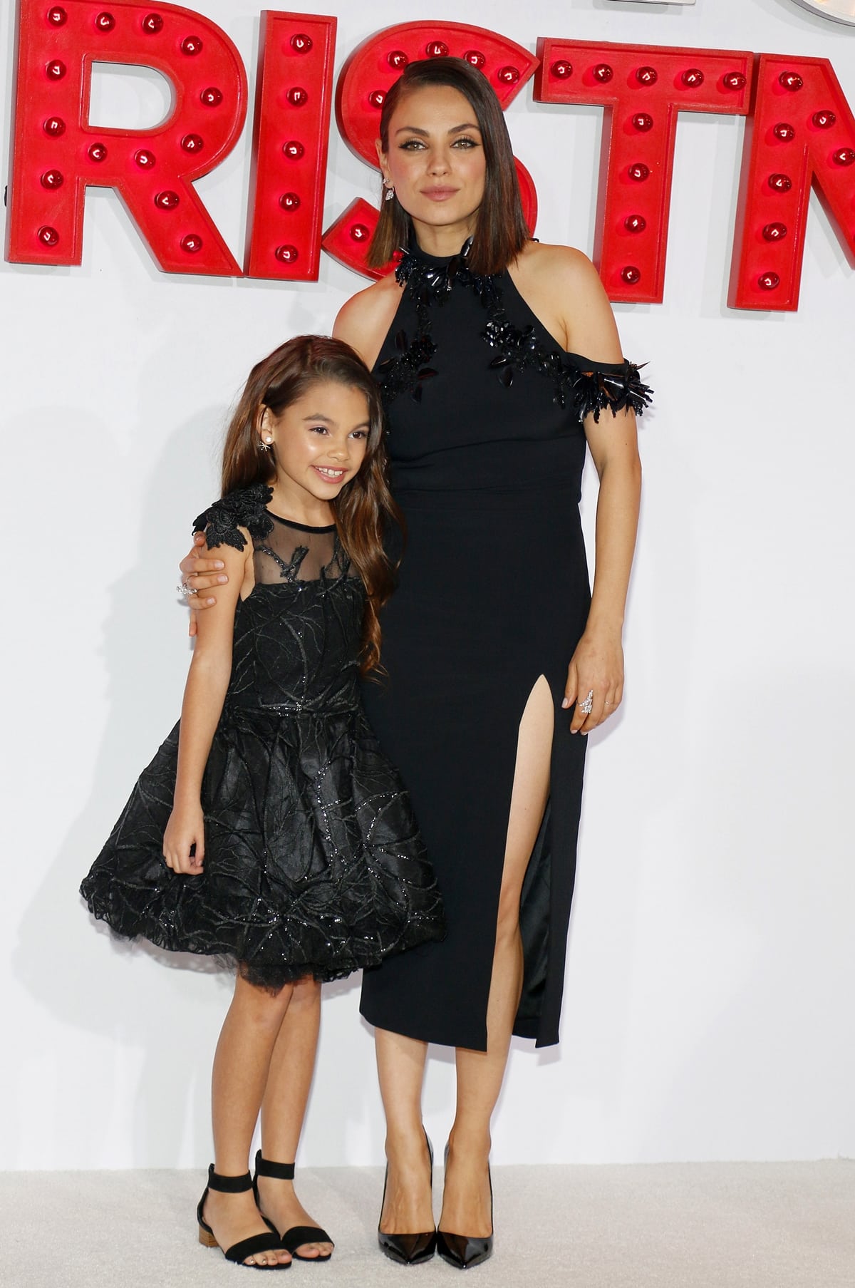 Mila Kunis paired a black Cushnie et Ochs dress with Christian Louboutin "So Kate" pumps, while young co-star Ariana Greenblatt complemented her in a black embroidered party dress at the A Bad Moms Christmas premiere in Westwood, California, on October 30, 2017