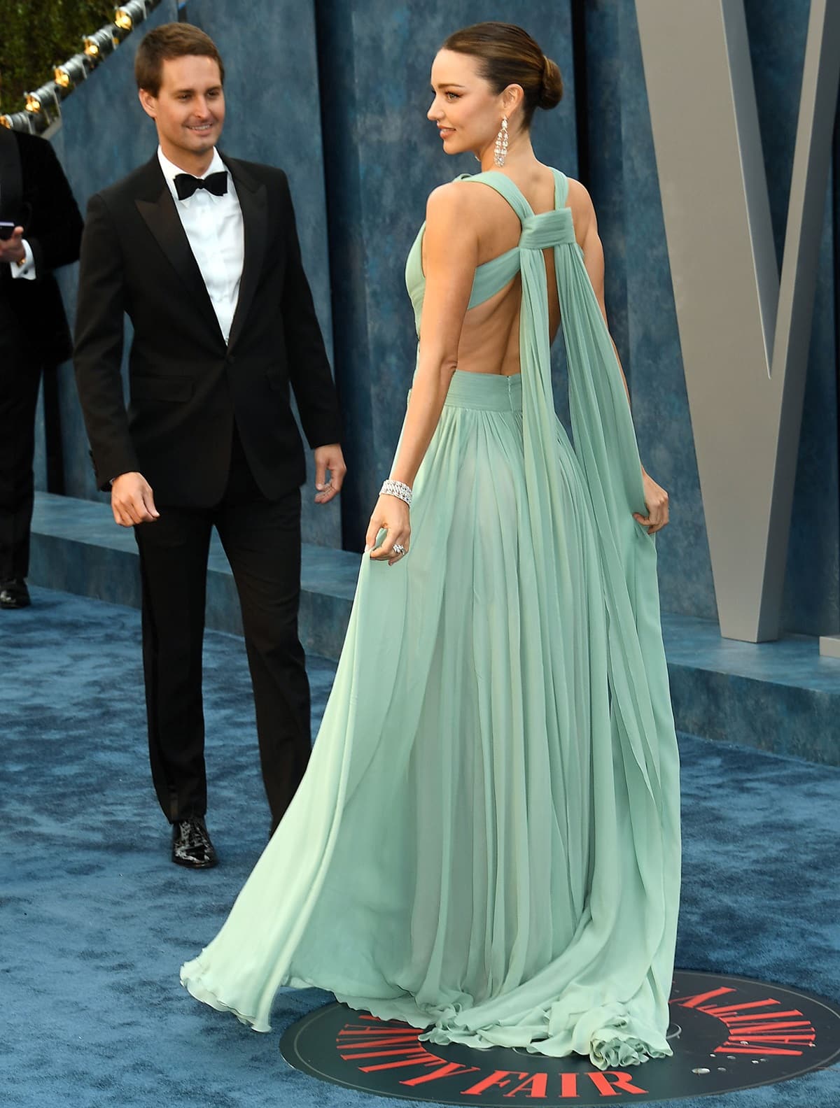 Miranda Kerr wore a strappy, aquamarine Elie Saab haute couture gown with intricate detailing on the back as she walked the red carpet with Evan Spiegel