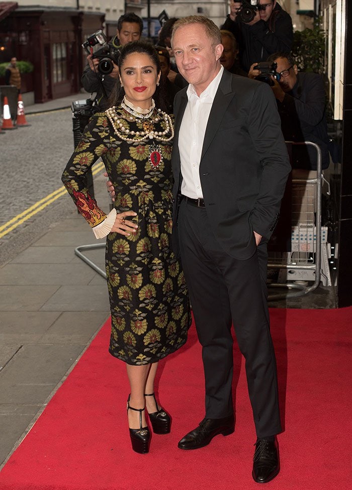 Salma Hayek poses with husband François-Henri Pinault at the Tale of Tales London premiere, exuding regal elegance in embroidered Gucci and sky-high platforms