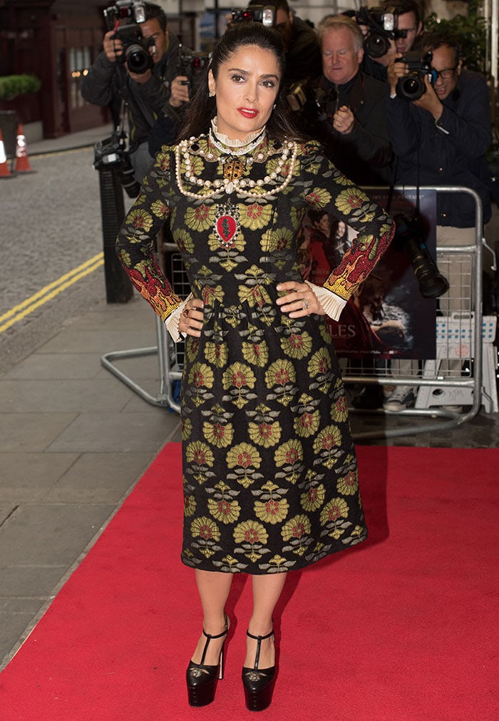 Striking a confident stance on the red carpet, Hayek showcases the medieval-inspired detailing of her Gucci Fall 2016 dress