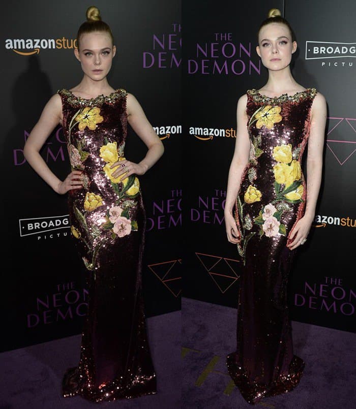 Elle Fanning stunned in a maroon sequin Dolce Gabbana gown adorned with vibrant floral appliques, perfectly balancing elegance and youthfulness at The Neon Demon LA premiere