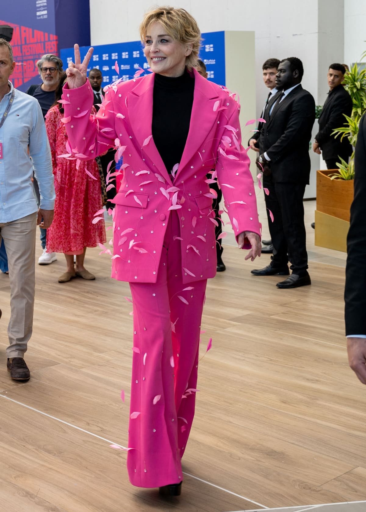 Sharon Stone exudes bold elegance in a vibrant pink feathered suit at the Red Sea International Film Festival, proving her status as a timeless style icon
