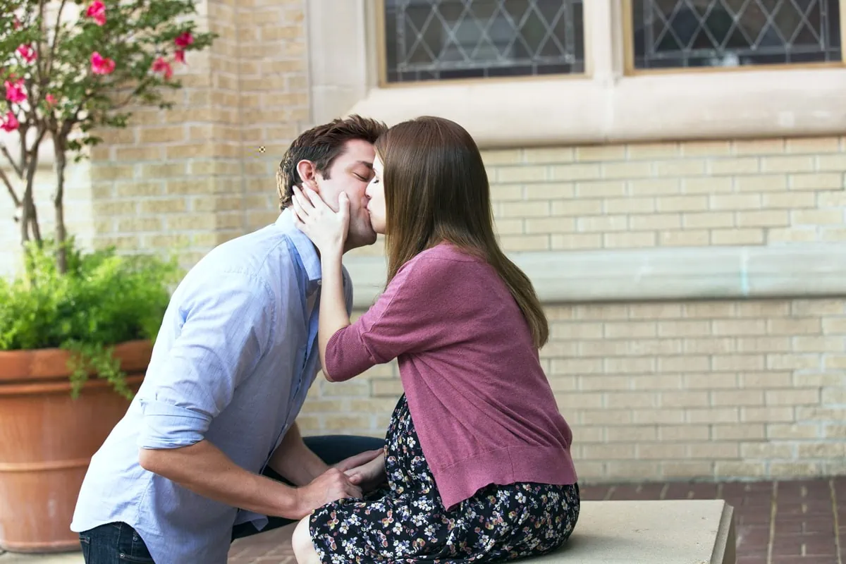 Anna Kendrick as Rebecca shares a tender moment with John Krasinski’s character John Hollar in The Hollars, where she plays his supportive pregnant girlfriend