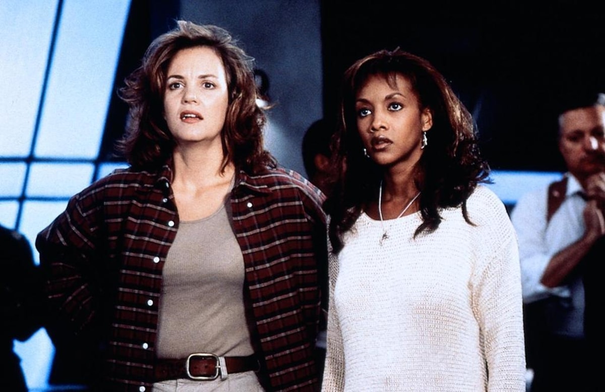 Vivica A. Fox as Jasmine Dubrow alongside Margaret Colin’s Constance Spano in the 1996 sci-fi blockbuster Independence Day — a role that helped cement Fox’s Hollywood rise and led to some of her most memorable red-carpet fashion moments