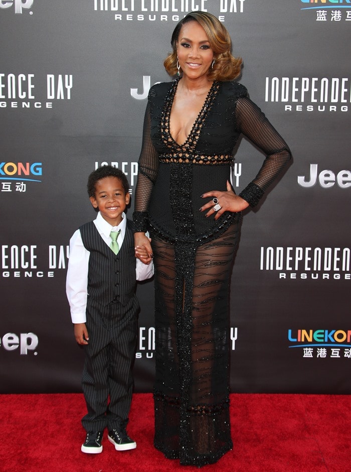 Vivica A. Fox, joined by her godson Christian Kelley, stuns in a custom black embellished Esé Azénabor gown with sheer paneling at the Independence Day: Resurgence premiere