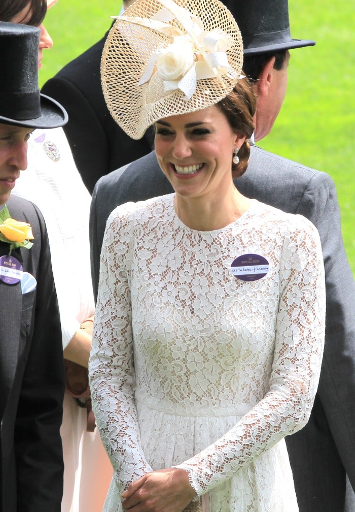 Kate Middleton wears a name tag on her white lace Dolce Gabbana dress