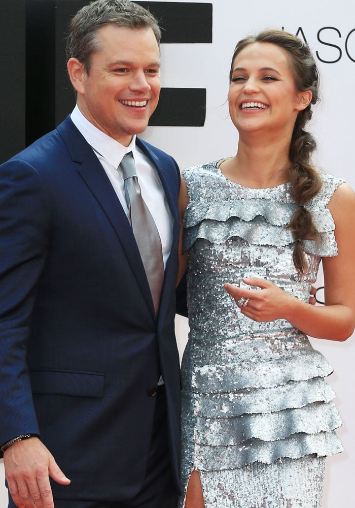 Matt Damon and Alicia Vikander share a laugh on the red carpet, with Vikander dazzling in a silver sequined Louis Vuitton gown at the European premiere of “Jason Bourne”