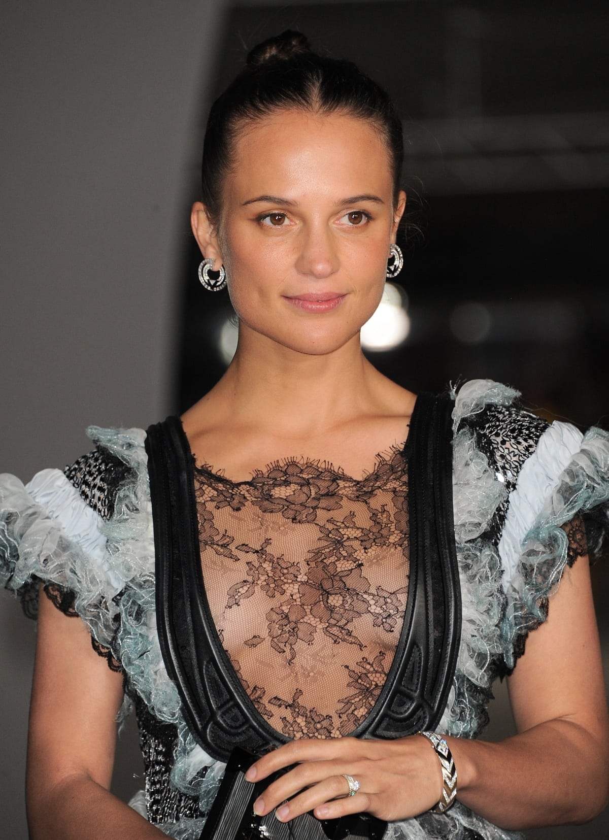 Alicia Vikander, whose heritage blends Swedish, Finnish, and distant Baltic German roots, brings a distinctive elegance to the red carpet in this ruffled lace Louis Vuitton creation