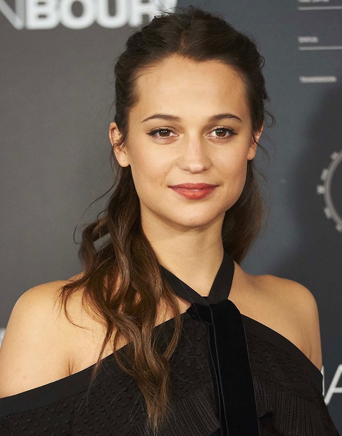 With soft waves pulled into a half-up style and fresh makeup, she completed the chic, understated look