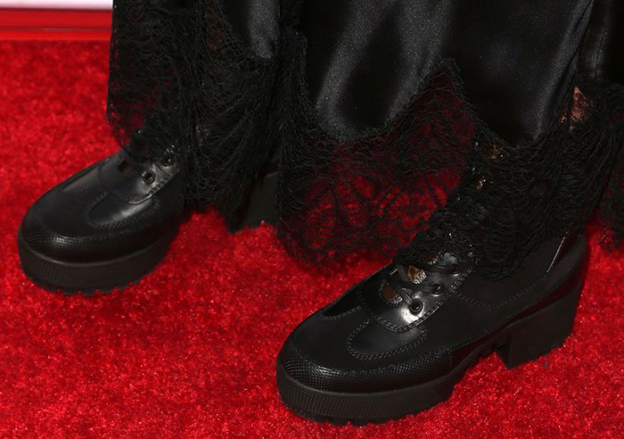 Ashley Tisdale grounded her silky black slip dress with chunky Louis Vuitton "Palm Canyon Desert" platform boots from the house's Cruise 2016 collection