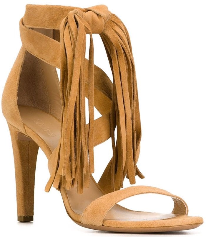 Chloé fringed suede sandals in warm tan, finished with a knotted ankle tie and cascading fringe that adds fluid movement to the minimalist silhouette