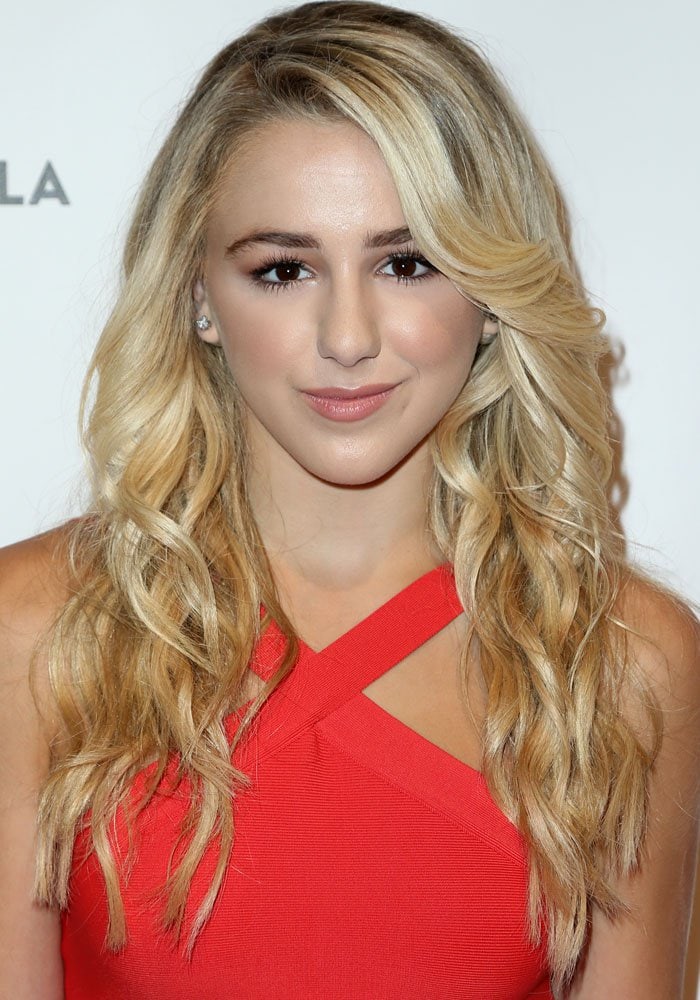 Chloe Lukasiak channels youthful polish with voluminous curls and a red halter dress, radiating confidence at BeautyCon LA 2016