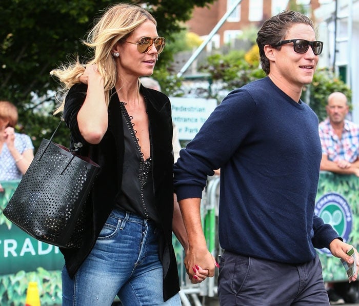 Hand in hand with Vito Schnabel, Heidi Klum anchors her casual denim with towering platforms that subtly elevate the entire ensemble