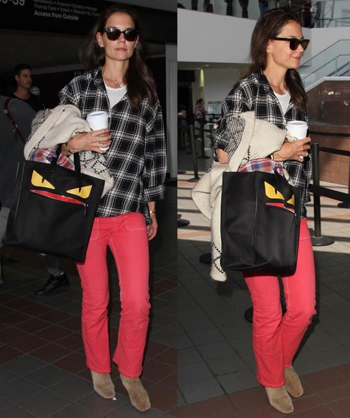 Katie Holmes kept it effortlessly casual at LAX in coral-red jeans, a plaid shirt, suede ankle boots, and her playful Fendi ‘Monster’ tote adding a pop of personality
