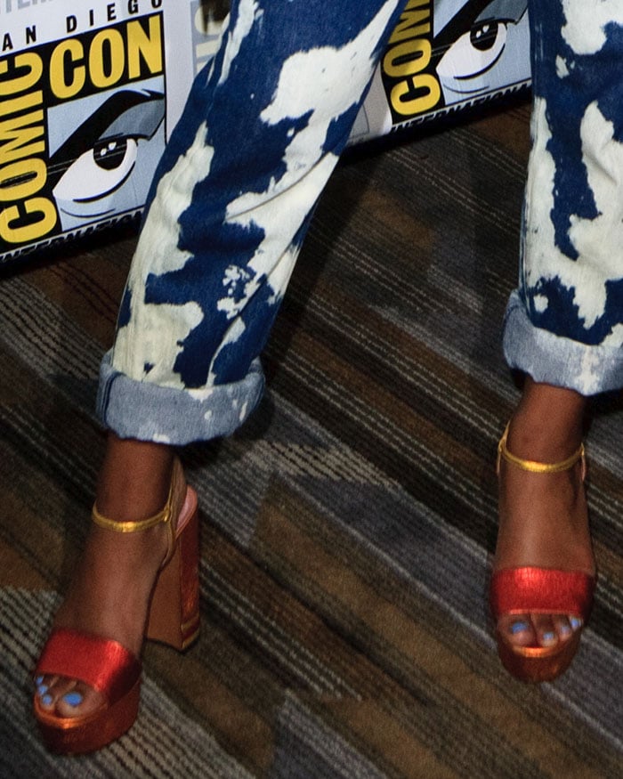 A close-up of Keke’s metallic Bally platform sandals reveals their striking two-tone straps and towering block heels