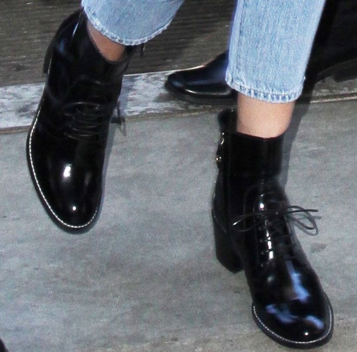 A closer look at Kendall Jenner’s glossy Louis Vuitton “Republic” patent leather ankle boots, featuring lace-up fronts, almond toes, and sturdy block heels that balance edgy style with all-day wearability