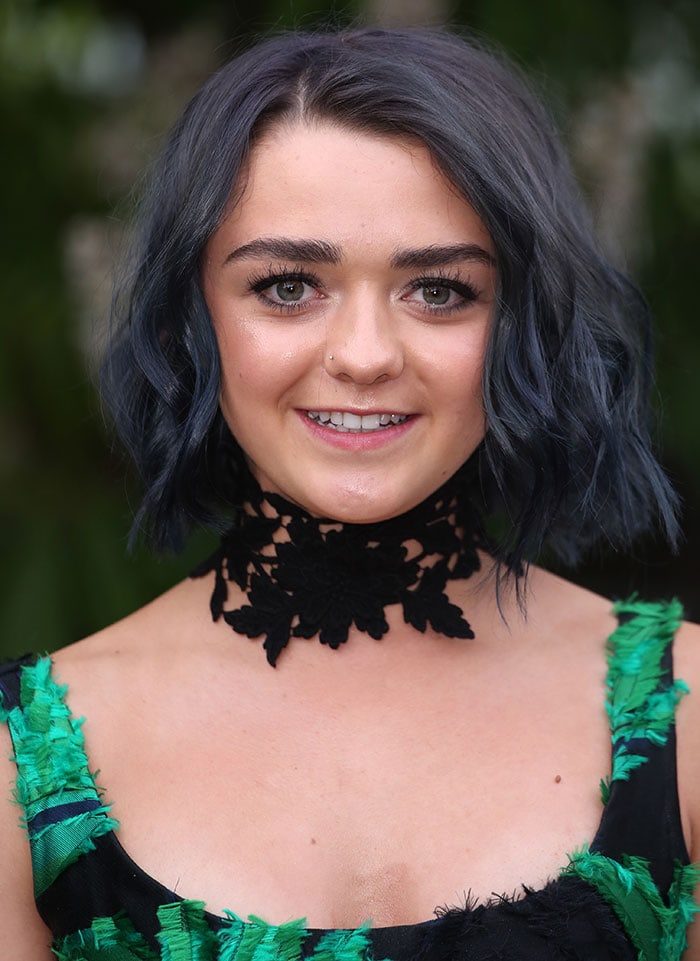 She debuted a sleek black bob with electric-blue highlights, styled with a bold Jessica Choay lace choker for extra edge
