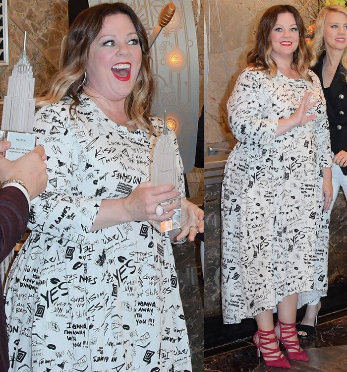 Melissa McCarthy radiates joy in a black-and-white graffiti-print midi dress and strappy pink Sole Society “Shayley” pumps at the Ghostbusters promotional event held at the Empire State Building on July 13, 2016, in New York City