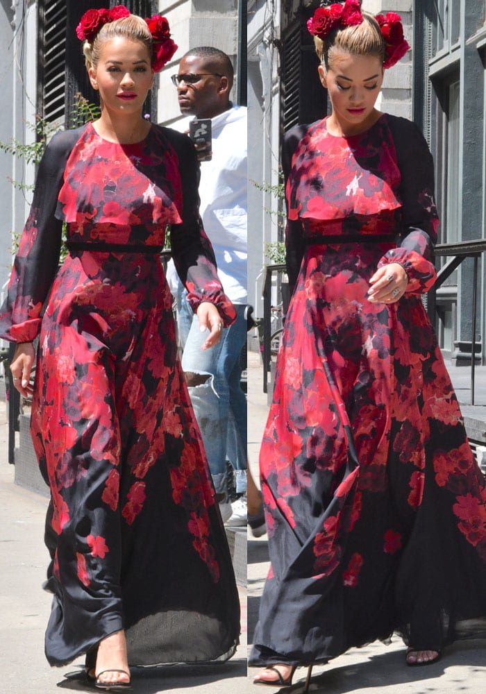 The sweeping red-and-black floral dress comes alive in motion as Rita Ora steps through New York, its fluid silhouette intentionally balanced by barely-there black stiletto sandals