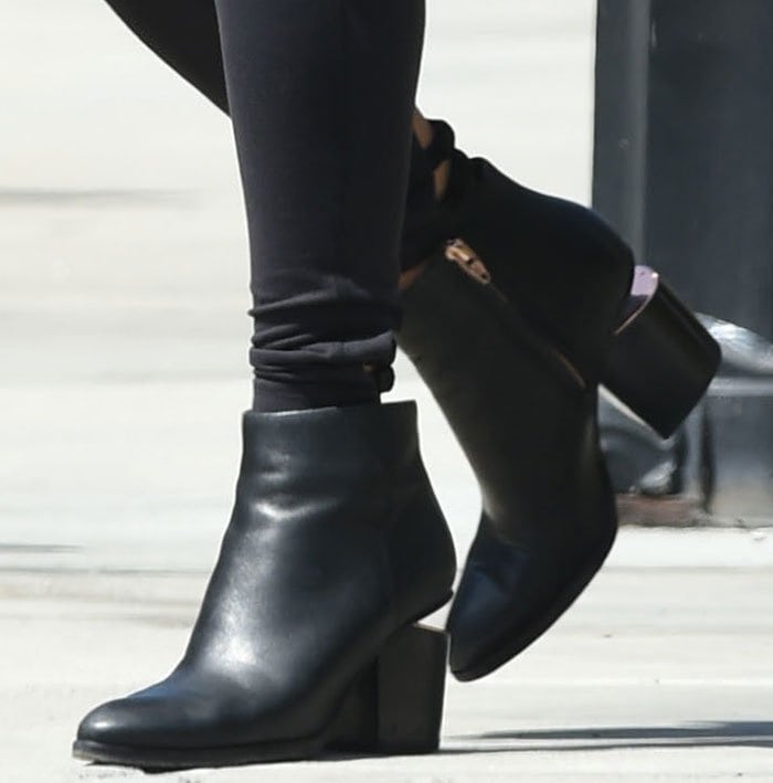 Vanessa Hudgens' leather ankle boots feature tapered toes and concealed side-zip closures