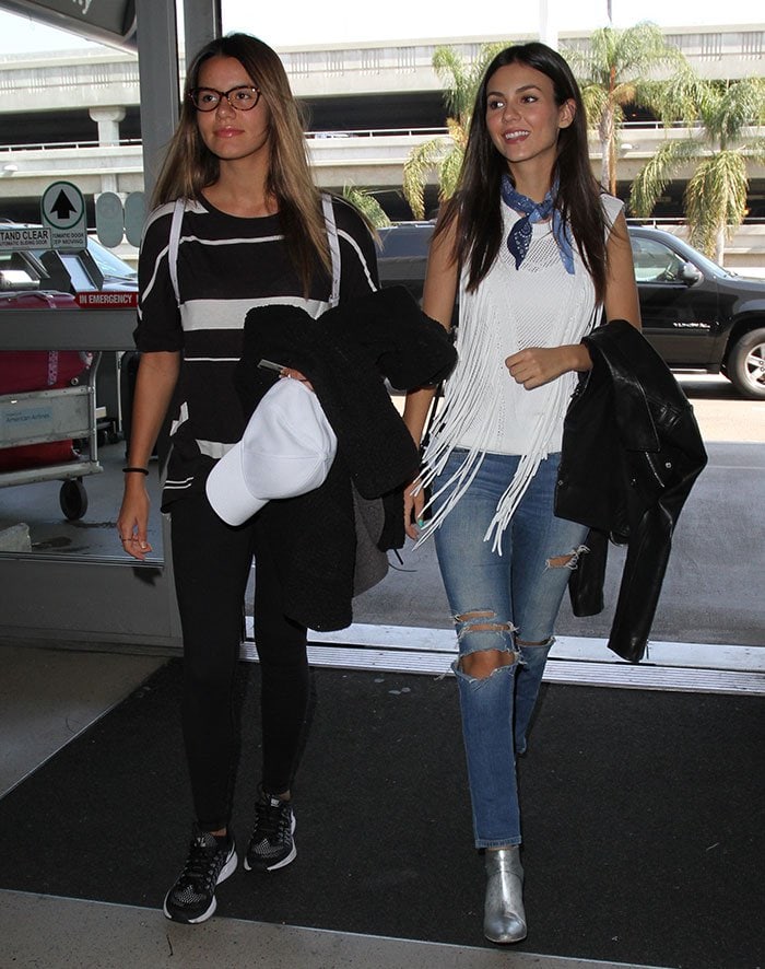 Victoria Justice walks through LAX with sister Madison Reed, showing off her Western-inspired outfit and standout silver ankle boots