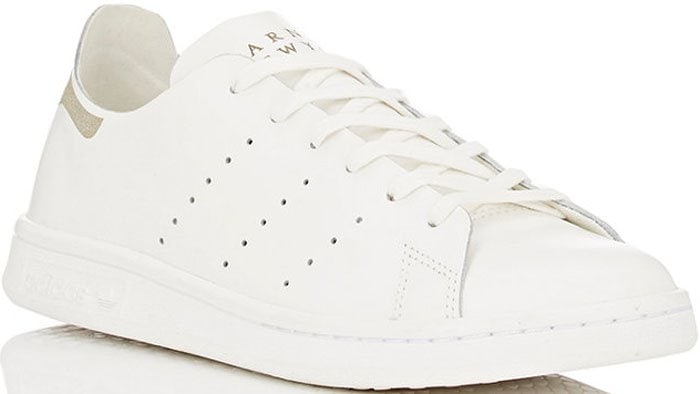 The Adidas x Barneys New York Deconstructed Stan Smith sneakers reimagine the iconic tennis silhouette with unlined premium leather, pared-back stitching, and subtle branding for a sleek, luxury-minimalist finish